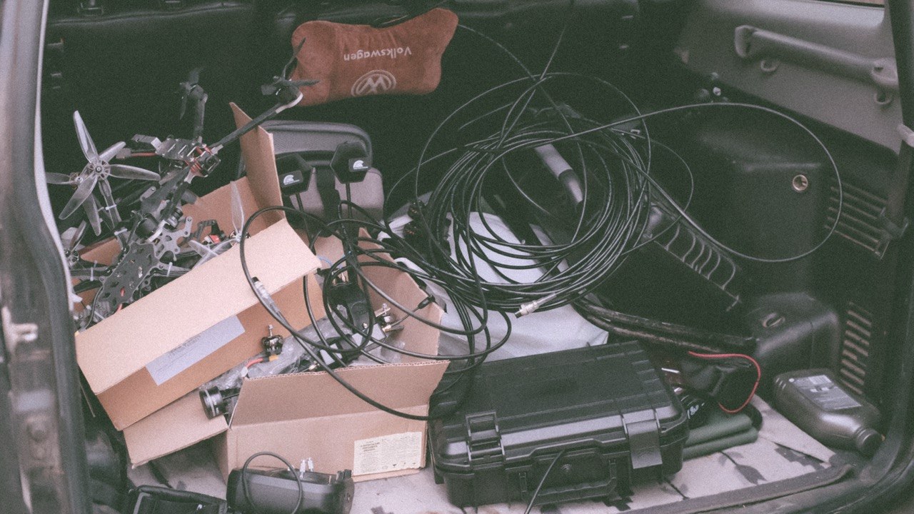 Vehicle boot loaded with airframes, cabling, antennas and transport cases before a field deployment