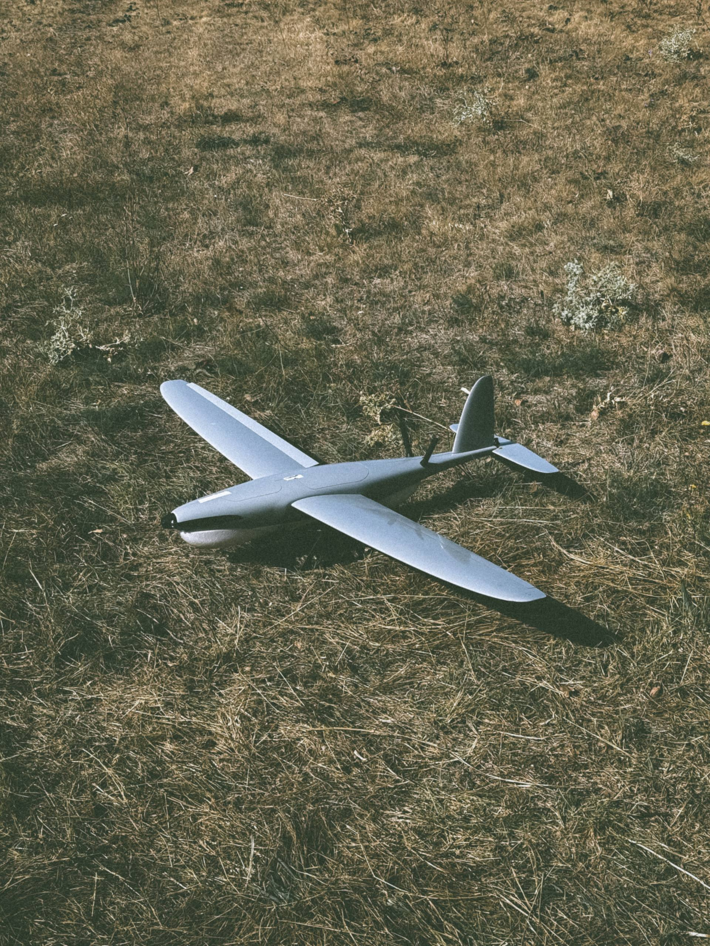 Fixed-wing unmanned system on a grass field